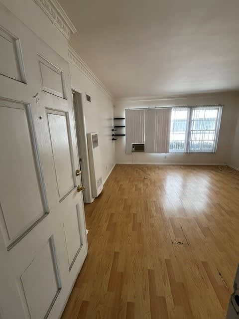 A room with wooden floors and white doors.