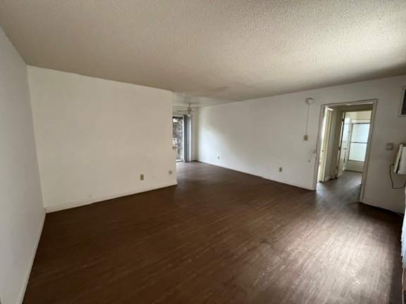 A room with wooden floors and white walls.