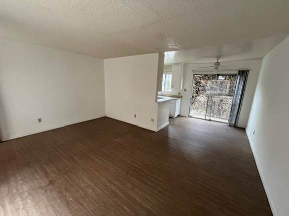 A room with wooden flooring and white walls.