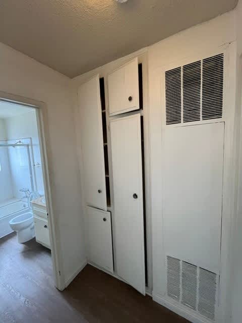 A white bathroom with a toilet, sink, and medicine cabinet.