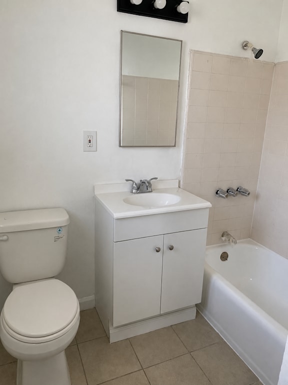 A white toilet sits next to a sink in a small bathroom.