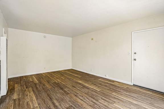 A room with wooden flooring and a white door.