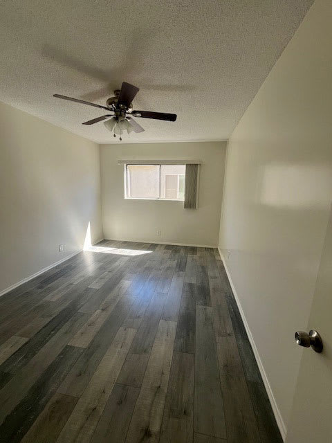 A room with a ceiling fan and a window.