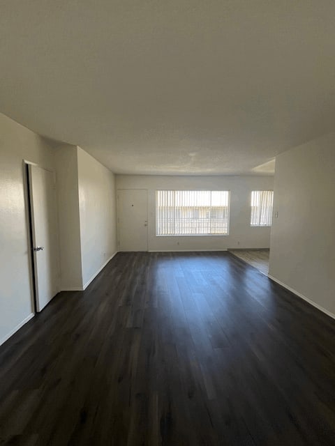 A room with wooden floors and white walls.