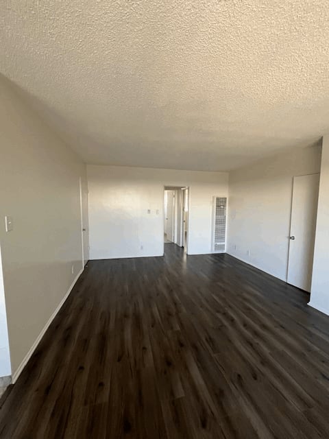 A room with wooden floors and white walls.