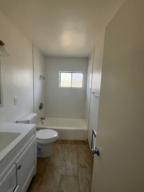 A white bathroom with a toilet, sink, and bathtub.