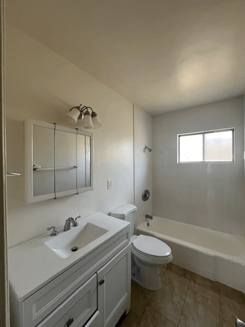 A white bathroom with a sink, toilet, and bathtub.