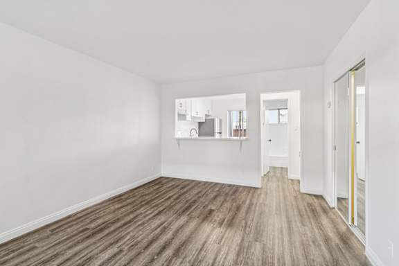 A room with a wooden floor and white walls.