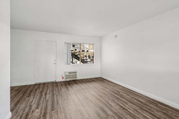 A room with a window and a radiator on the wall.