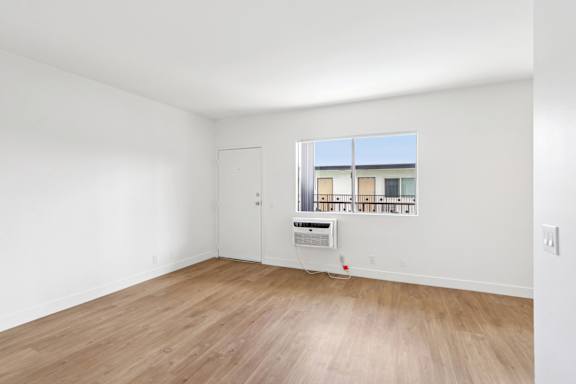 A room with a window and a door.