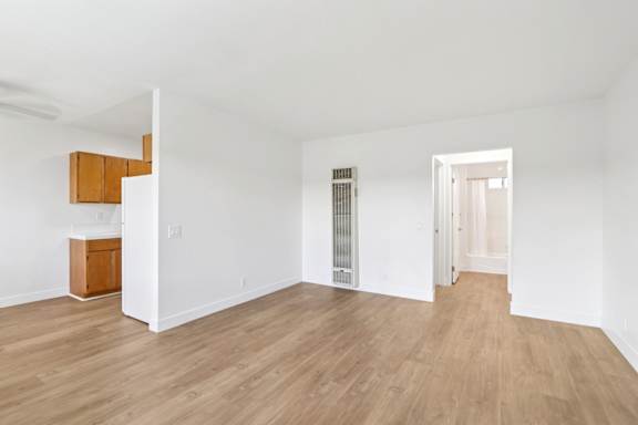 A room with wooden floors and white walls.