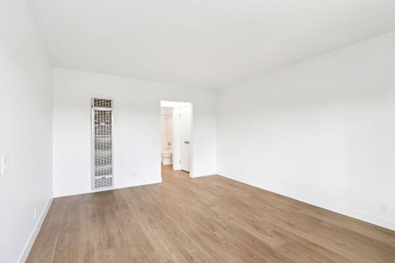 A room with wooden floors and white walls.