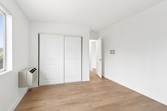 A room with a white wall and a white door.