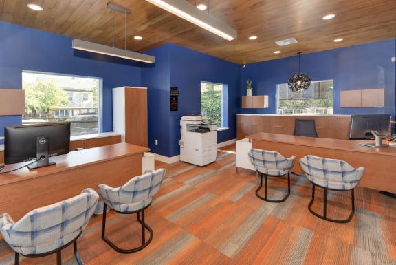 Leasing office employee workspace.  Walls are a bright blue color and the flooring is orange.at Folsom Ranch, Folsom