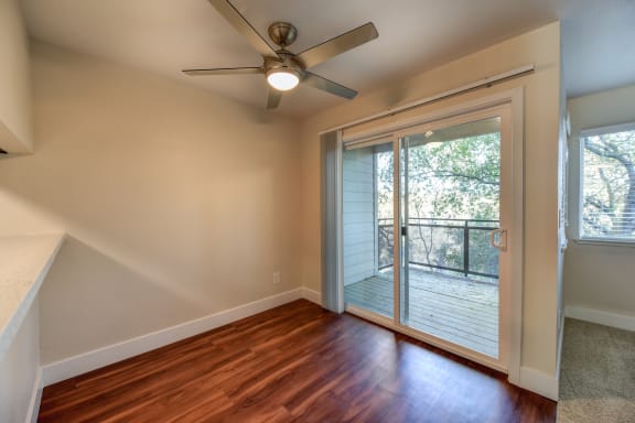 Vacant apartment home with ceiling fan in the dining area.  Sliding glass door leading to the balcony is off of the dining area.at Folsom Ranch, Folsom, CA, 95630