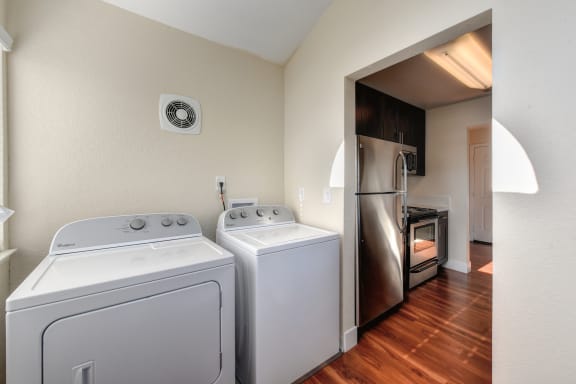 Full sized washer and dryer, side by side, located outside of the kitchen on this floor plan at Folsom Ranch, Folsom