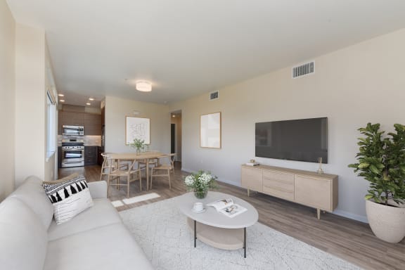 a living room with a couch and a table and a television  at Addison Ranch Apartments, Petaluma, CA