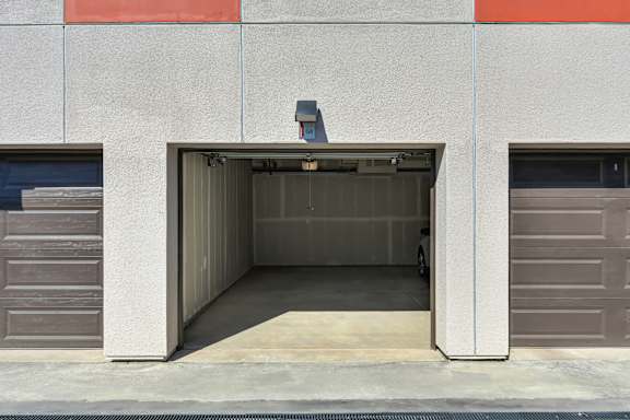 A car is parked in a garage door.