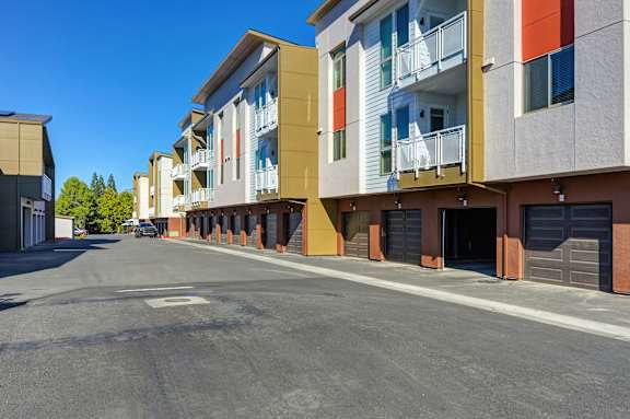 A street view of a residential area with apartment buildings on both sides.
