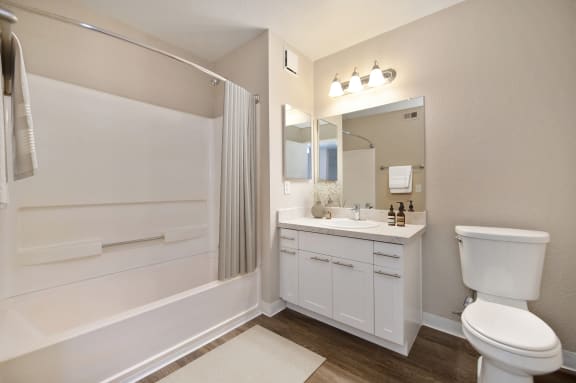 a bathroom with a toilet sink and a shower