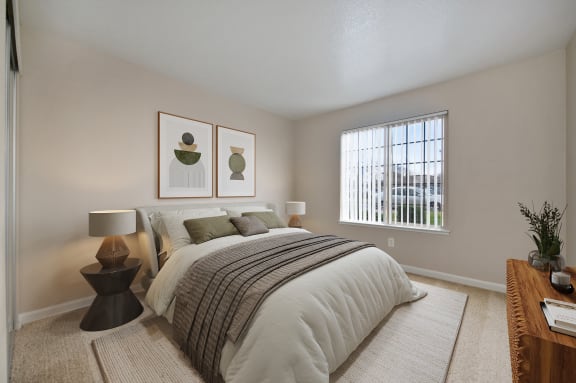 a bedroom with a bed and two paintings on the wall