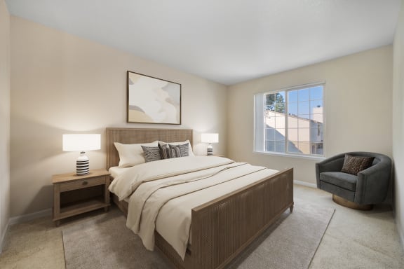 a bedroom with a bed and a chair and a window