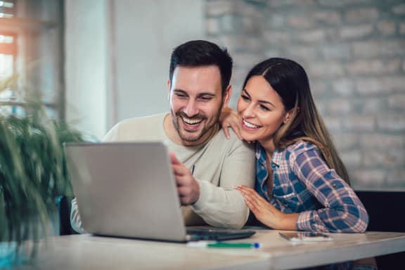 Couple on laptop computer together. at Silverstone Apartments, Davis, CA, 95618