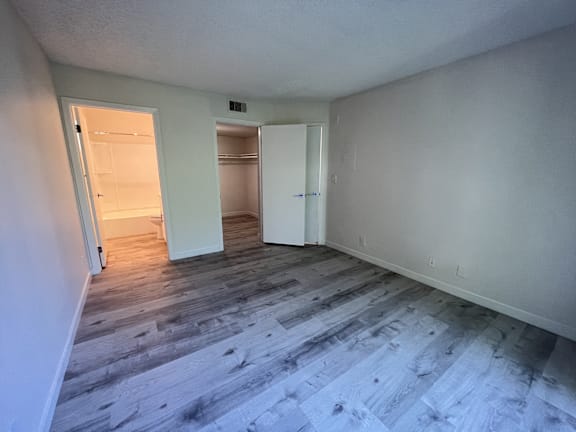 A room with a wooden floor and white walls.