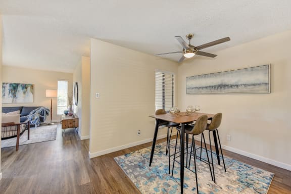 Dining Area, Ceiling Fan, Hardwood Inspired Floor, and Rug at Silverstone Apartments, Davis, California