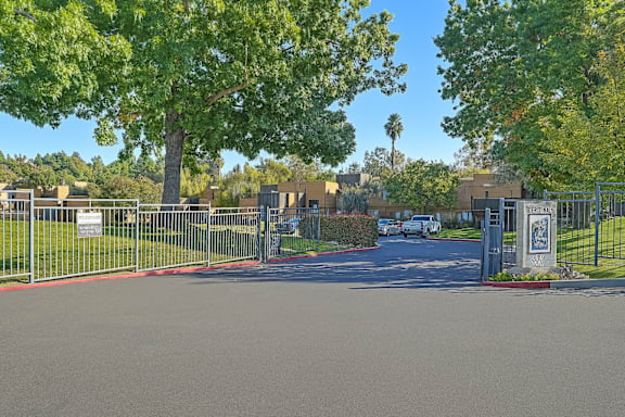 A gated entrance to a residential area with a sign on the gate at Fountains of Fair Oaks, Fair Oaks