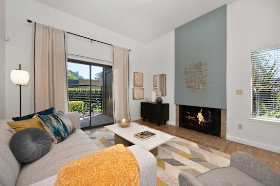 a living room with a couch and a fireplace at Fountains of Fair Oaks, California, 95628