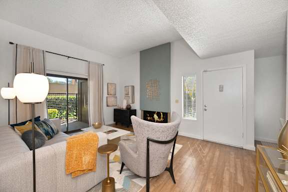a living room with a couch and a chair and a fireplace at Fountains of Fair Oaks, Fair Oaks