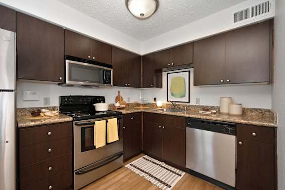 full kitchen with stainless steel appliances and granite counter tops at Fountains of Fair Oaks, Fair Oaks, California