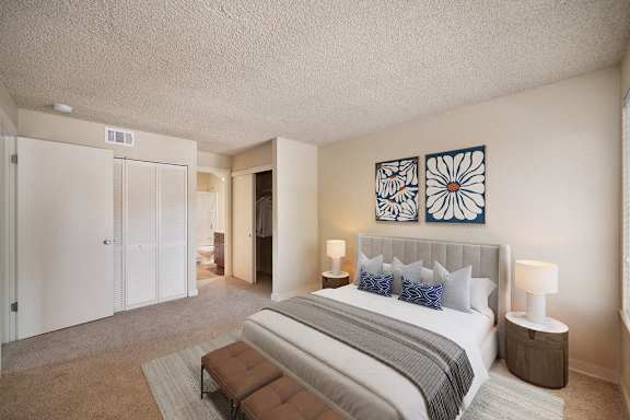 a bedroom with a bed and two seperate closet areas and access to the bathroom. at Fountains of Fair Oaks, Fair Oaks, CA