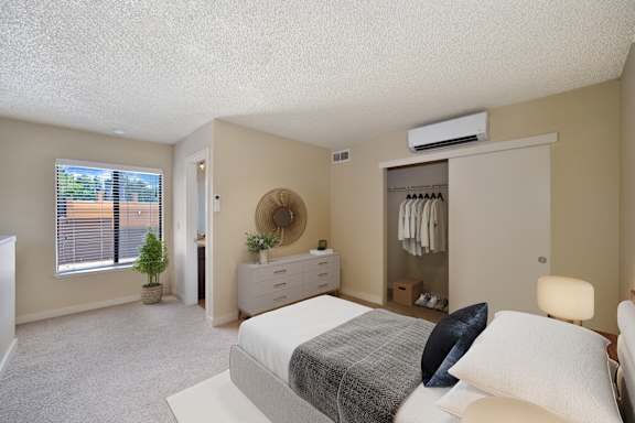 a bedroom with a bed and a closet and a window at Fountains of Fair Oaks, California, 95628