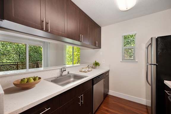A kitchen with brown cabinets and a black refrigerator at Folsom Ranch, Folsom, CA, 95630