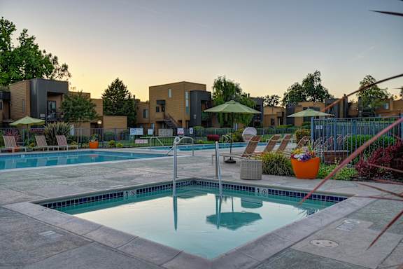 A swimming pool surrounded by a patio and a fence at Fountains of Fair Oaks, Fair Oaks