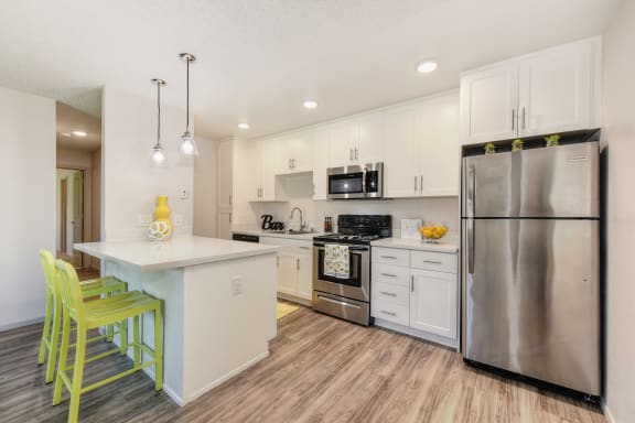 2 bedroom, one bath floor plan kitchen showing white cabinets, quartz counters and stainless appliances. at Pinecrest Apartments, California, 95616
