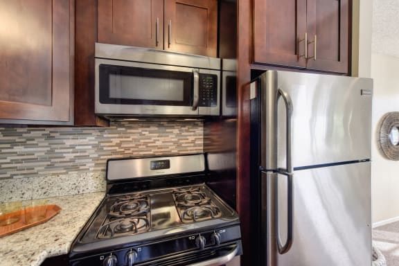 Kitchen with Refrigerator, Microwave, Wood Cabinets and Oven