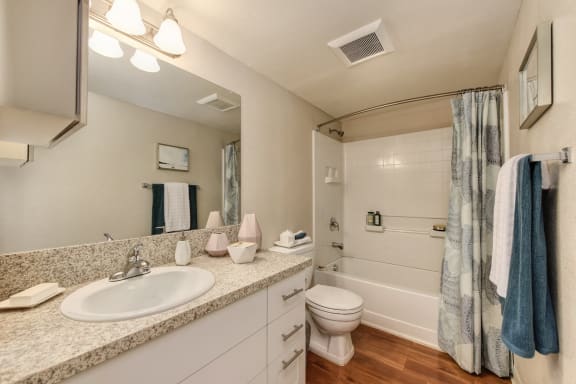 Master Bathroom with Wood Inspired Floor, Toilet, Bathtub, Full Vanity at Addison Ranch Apartments, California, 94954