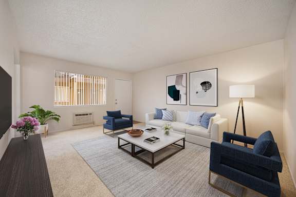 A living room with a blue chair and a coffee table. at Olympus Park Apartments, California