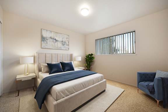 A bedroom with a large bed and a blue chair at Olympus Park Apartments, Roseville, California