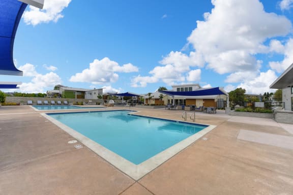 Pool with Lounge Chairs, Blue Skies with Clouds at Addison Ranch Apartments, Petaluma, California