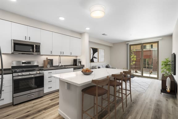 a kitchen with white cabinets and a large island with a white countertop