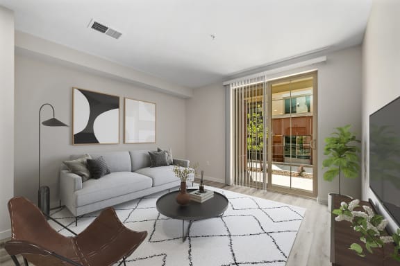 a living room with a white couch and a black coffee table