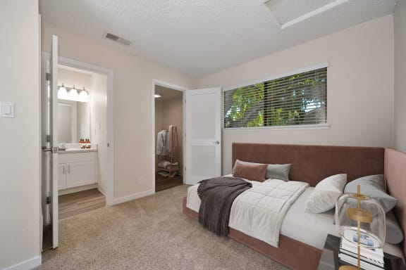 a bedroom with a large bed and a bathroom with a shower at Silverstone Apartments, Davis
