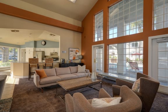 a living room with couches and chairs and large windows at The Legacy Apartments, Antelope 95843