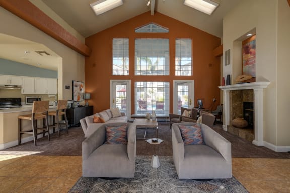 a living room with couches and chairs and a fireplace at The Legacy Apartments, Antelope, CA