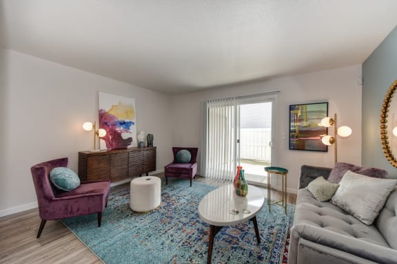 a living room with a couch and chairs and a table