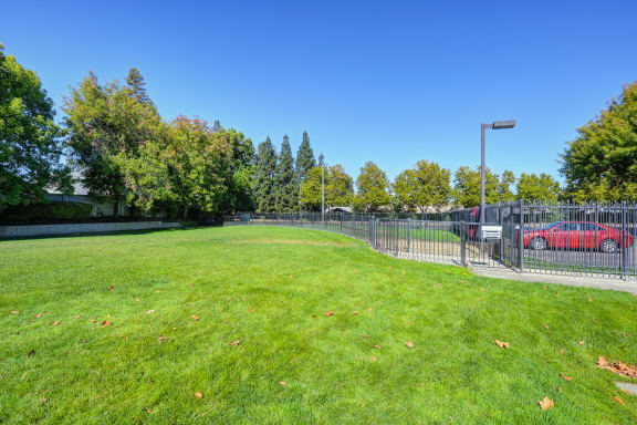 a park with a grass field and a fence at The Legacy Apartments, Antelope, CA, 95843
